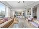 An open-concept living room, featuring a cozy seating area that flows seamlessly into the modern kitchen at 650 Village Crest Dr, Suwanee, GA 30024