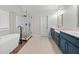 Modern main bathroom with a soaking tub, glass shower, and dual vanities at 650 Village Crest Dr, Suwanee, GA 30024