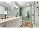 Bathroom with double sink vanity, framed mirrors, updated fixtures, and a glass enclosed tiled shower at 981 Cobb Place Manor Dr, Marietta, GA 30066