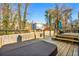 Inviting deck with a hot tub, seating, and a peaceful backyard view at 981 Cobb Place Manor Dr, Marietta, GA 30066