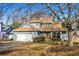 Front exterior view of a two-story home with landscaped yard, covered front porch, and attached garage at 981 Cobb Place Manor Dr, Marietta, GA 30066