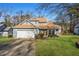 Charming two-story home with a well-manicured lawn, attached garage, and inviting front entrance at 981 Cobb Place Manor Dr, Marietta, GA 30066