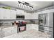 Updated kitchen features granite countertops, stainless steel appliances, and stylish lighting at 981 Cobb Place Manor Dr, Marietta, GA 30066