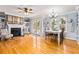 Open concept living room, fireplace, and dining area with hardwood floors at 981 Cobb Place Manor Dr, Marietta, GA 30066