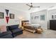 Cozy bedroom with comfortable seating area, ceiling fan, and natural light at 1205 New Haven Ct, Roswell, GA 30075
