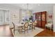 Dining room with hardwood floors, a large window and decorative chandelier at 1205 New Haven Ct, Roswell, GA 30075