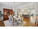 Dining room with hardwood floors and chandelier lighting, flows into kitchen with island at 1205 New Haven Ct, Roswell, GA 30075