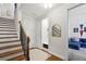 Inviting entryway with wood stairs, storage, and stylish decor at 1205 New Haven Ct, Roswell, GA 30075