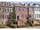 Brick townhome with dormers and landscaped front, showcasing curb appeal at 1205 New Haven Ct, Roswell, GA 30075