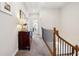 Well-lit hallway with decorative furniture, elegant railing, and neutral paint at 1205 New Haven Ct, Roswell, GA 30075