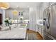 Kitchen with stainless steel refrigerator, marble countertops and open floor plan at 1205 New Haven Ct, Roswell, GA 30075