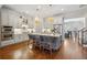 Modern kitchen with island seating, stainless steel appliances, and hardwood floors at 1205 New Haven Ct, Roswell, GA 30075