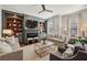 Inviting living room with custom built-ins, fireplace, ceiling fan, and neutral decor at 1205 New Haven Ct, Roswell, GA 30075