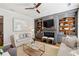 Comfortable living room with built-in shelves and fireplace at 1205 New Haven Ct, Roswell, GA 30075