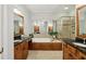 Spacious main bathroom with dual vanities, a tub, and a glass-enclosed shower at 1205 New Haven Ct, Roswell, GA 30075