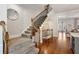 A foyer staircase with carpeted steps and dark iron spindles at 1205 New Haven Ct, Roswell, GA 30075