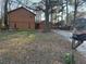 Side view of the home with a detached garage and mailbox at the street at 2820 Bluebird Cir, Duluth, GA 30096