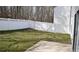 Large backyard enclosed by white fence, offering privacy and space for outdoor activities at 235 Woodland Way, Canton, GA 30114