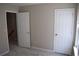 Bedroom with two doors, carpet, and natural light from the window to enhance space at 235 Woodland Way, Canton, GA 30114