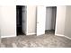 Bedroom showcasing plush carpeting and open doorways to the bathroom and walk-in closet at 235 Woodland Way, Canton, GA 30114