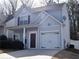 View of the front of a home with gray siding, dark shutters, and an attached one car garage at 235 Woodland Way, Canton, GA 30114