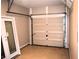 Interior of a one car garage with door parts and a door laying on the floor at 235 Woodland Way, Canton, GA 30114