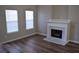 Bright living room featuring wood floors, a fireplace with marble hearth, and two windows at 235 Woodland Way, Canton, GA 30114