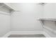 Walk-in closet with shelves for clothes and accessory storage and gray wood floors at 40 Oak Forest Dr, Oxford, GA 30054