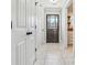 Bright hallway with tile floors and white doors leads to various rooms, offering a glimpse of the home's layout at 40 Oak Forest Dr, Oxford, GA 30054