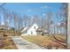 New home with three car garage, stone accents, and a long driveway nestled among mature trees at 40 Oak Forest Dr, Oxford, GA 30054