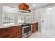 Well-designed kitchen featuring a large island with built-in cooktop, open access to another room and an elegant hood at 40 Oak Forest Dr, Oxford, GA 30054