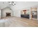 Open-concept living space features hardwood floors, a stone fireplace, and kitchen view at 40 Oak Forest Dr, Oxford, GA 30054