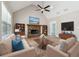 Bright living room with vaulted ceiling, stone fireplace, hardwood floors, and built-in bookshelves at 40 Oak Forest Dr, Oxford, GA 30054