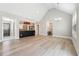 Bright open floor plan featuring hardwood floors, a kitchen view, and modern lighting at 40 Oak Forest Dr, Oxford, GA 30054