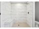 Walk-in shower boasts marble tile and a built-in bench in a modern bathroom at 40 Oak Forest Dr, Oxford, GA 30054