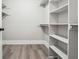 Walk-in closet features custom shelving and hardwood floors, ready for organization at 40 Oak Forest Dr, Oxford, GA 30054