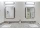 Bathroom featuring double vanity sinks with granite countertops, modern lights and mirrors, plus a shower stall at 5729 Newnan Cir, Austell, GA 30106