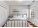Cozy bedroom with a blue metal bed frame, wood floors, two windows for ample lighting, and a closet at 5729 Newnan Cir, Austell, GA 30106