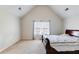 Vaulted bedroom featuring cozy carpet, natural light, and neutral paint at 5729 Newnan Cir, Austell, GA 30106