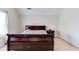 Comfortable carpeted bedroom featuring a large bed, a window and neutral paint at 5729 Newnan Cir, Austell, GA 30106