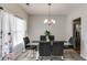 Bright dining room with a glass table, seating for six, and large window at 5729 Newnan Cir, Austell, GA 30106