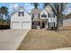 Charming two-story traditional home featuring an attached two-car garage and manicured landscaping at 5729 Newnan Cir, Austell, GA 30106