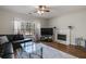 Comfortable living room with fireplace, hardwood floors, and a leather couch at 5729 Newnan Cir, Austell, GA 30106