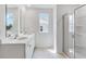 Bright bathroom features a double vanity with chrome fixtures and a glass-enclosed shower at 201 Groveton Ct, Euharlee, GA 30145