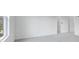 Minimalist bedroom with light gray carpet, neutral walls, and ample natural light at 201 Groveton Ct, Euharlee, GA 30145