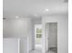 Bright hallway with neutral carpet and white walls leading to rooms with natural light at 201 Groveton Ct, Euharlee, GA 30145