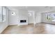 Open-concept living space with hardwood floors and a sleek, built-in fireplace at 201 Groveton Ct, Euharlee, GA 30145