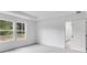 Bright primary bedroom with two windows and gray carpet, complemented by a sleek tray ceiling at 201 Groveton Ct, Euharlee, GA 30145