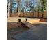 Landscaped backyard featuring a wooden fence, retaining walls, and stone stairs leading to the lawn at 264 Haas Ave, Atlanta, GA 30316