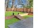 Spacious, fenced backyard features lush green grass, wooden retaining walls, and stamped concrete patio at 264 Haas Ave, Atlanta, GA 30316